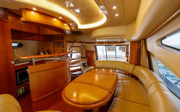 Luxury yacht interior with dining area and ocean view.