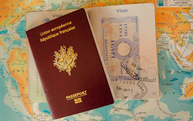 Passport and visas on a world map, representing Vietnam E-Visa Online Service for tourists.