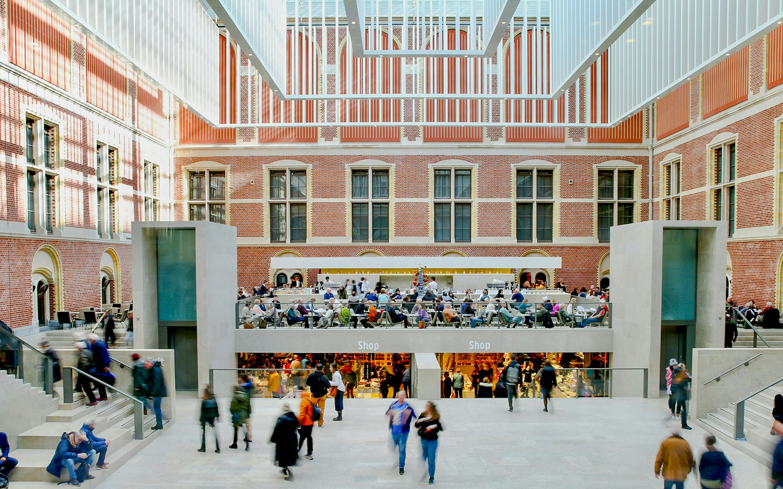 Rijksmuseum main hall with visitors and shops in Amsterdam.