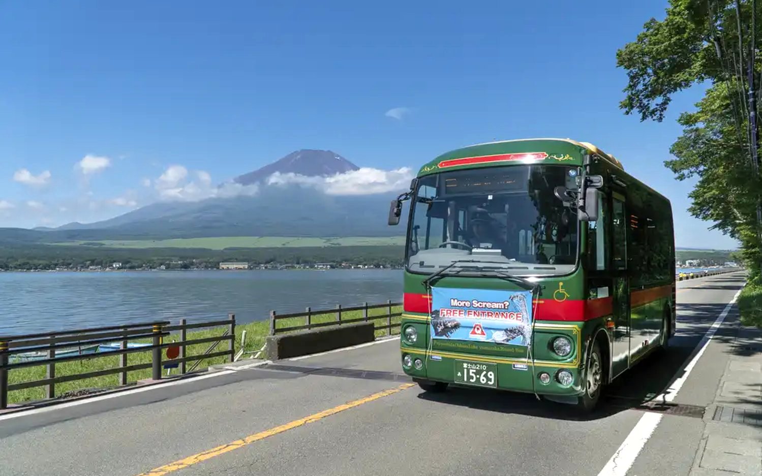 Bus near Lake Yamanaka with Mount Fuji in background, Japan.