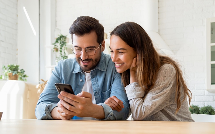 Couple booking National Coach Museum tickets online in Lisbon.