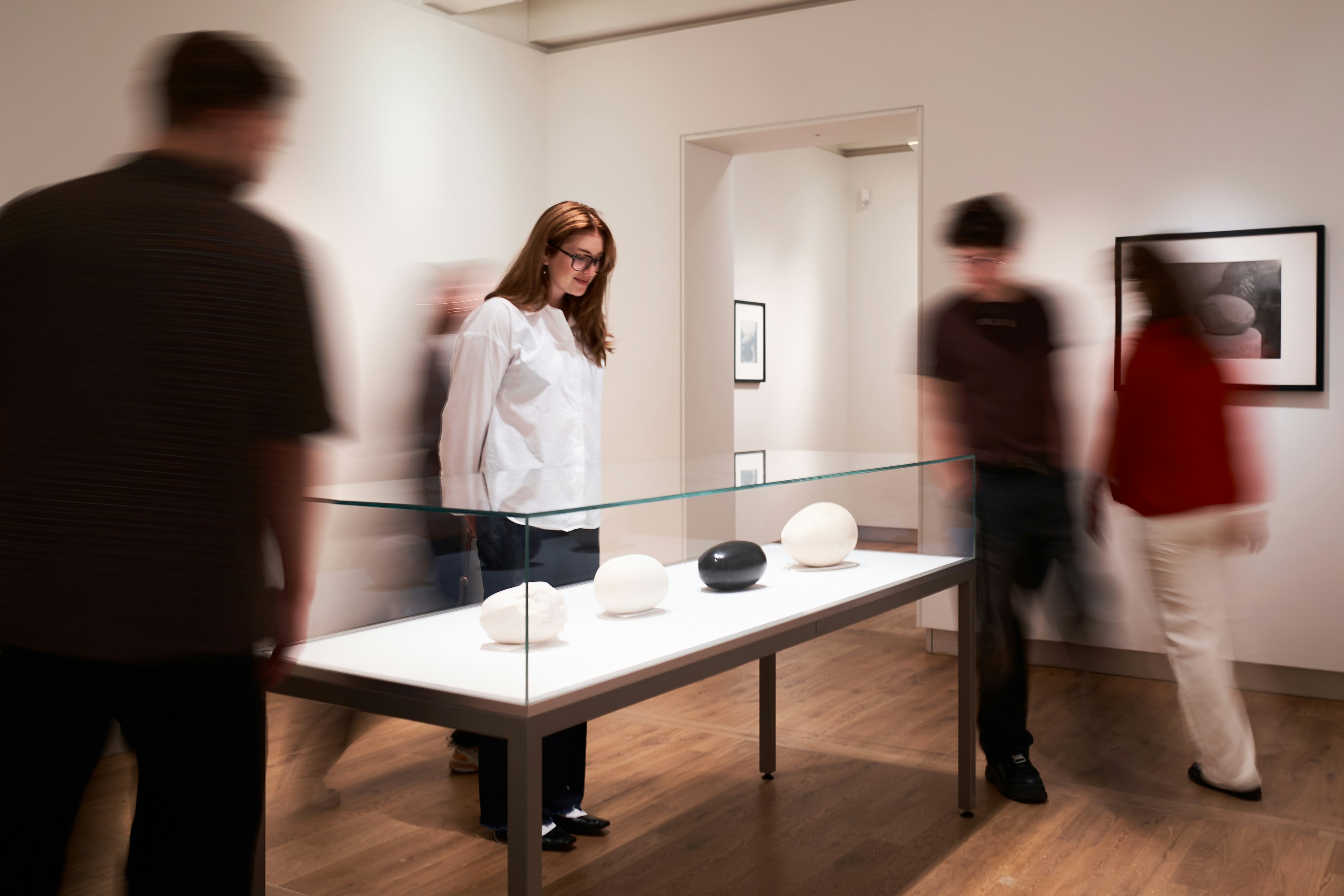 Guests viewing sculptures at H’ART Museum exhibit.
