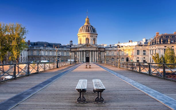 Pont des Arts bridge leading to Institut de France, Paris, featured in Emily in Paris tour.