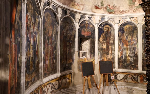 Iconography inside Onufri National Iconographic Museum, Berat, featuring religious frescoes.