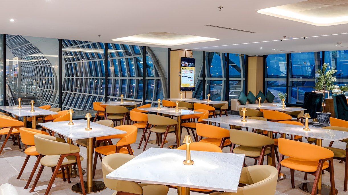 Coral Cosmo Lounge seating area with tables and chairs, Concourse C, Bangkok airport, Thailand.