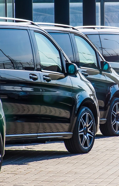 Minivans lined up for Athens airport transfer service.