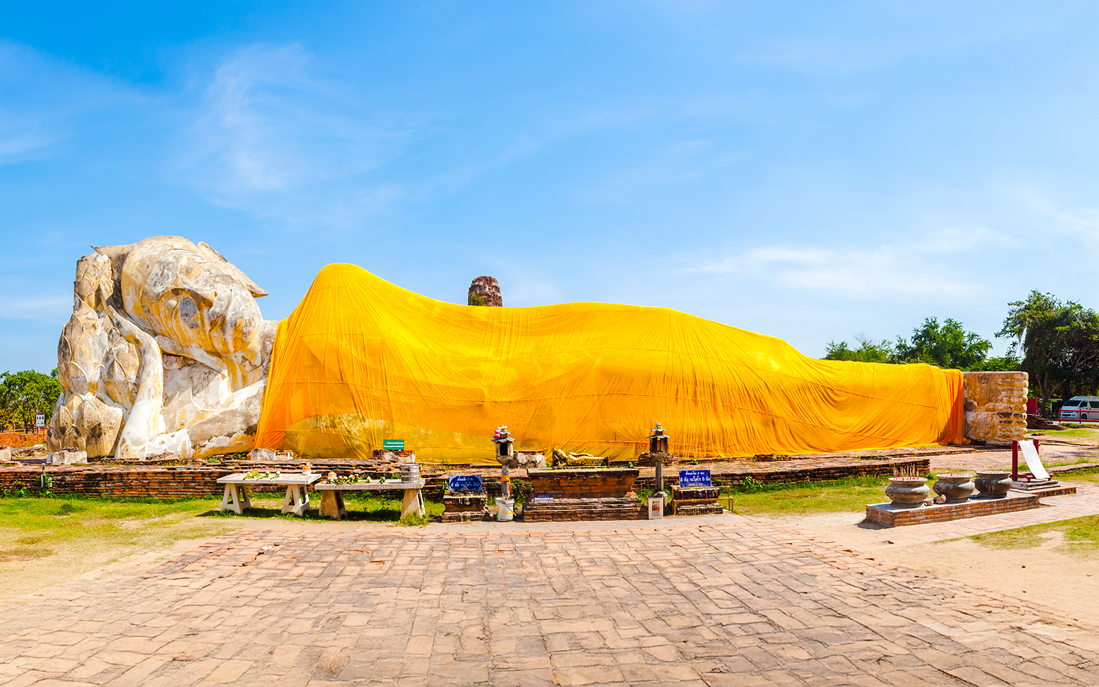 Reclining Buddha statue draped in yellow cloth at Wat Lokayasutharam, Ayutthaya, Thailand.