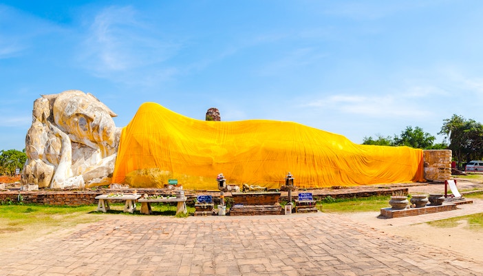 Reclining Buddha statue draped in yellow cloth at Wat Lokayasutharam, Ayutthaya, Thailand.