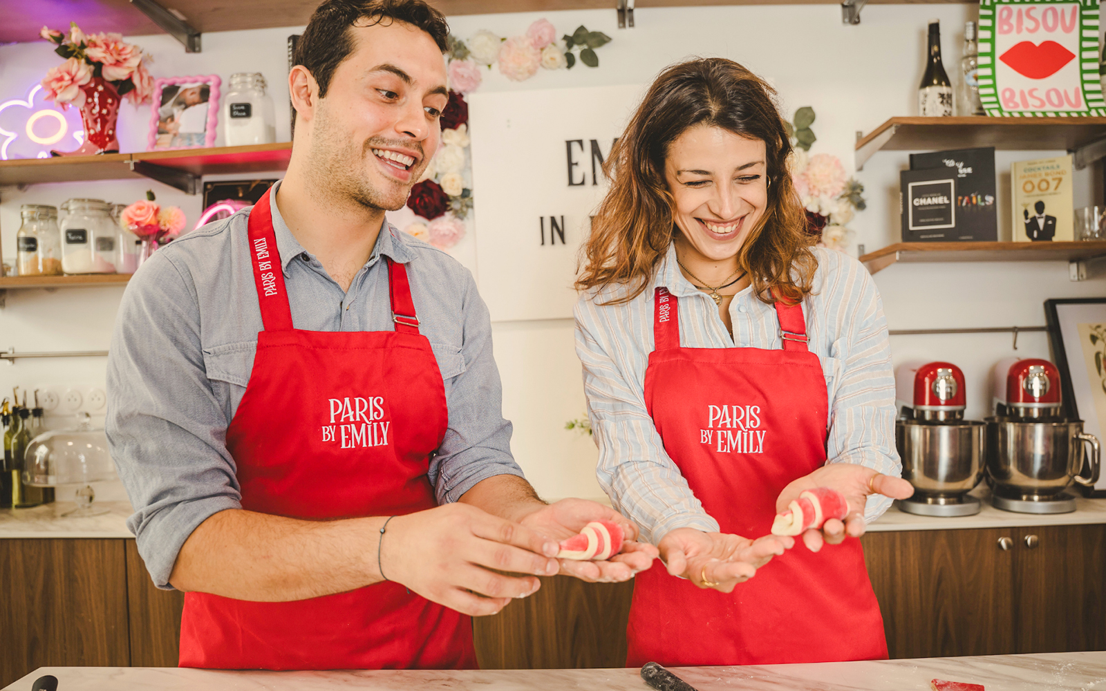 People holding croissants at Emily in Paris Croissant-Making Workshop.
