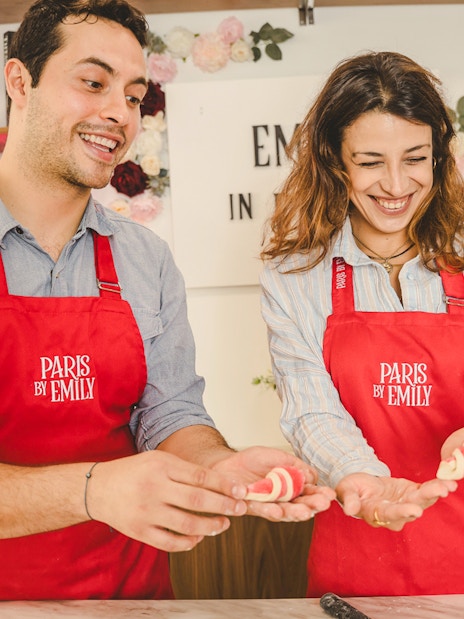 People holding croissants at Emily in Paris Croissant-Making Workshop.