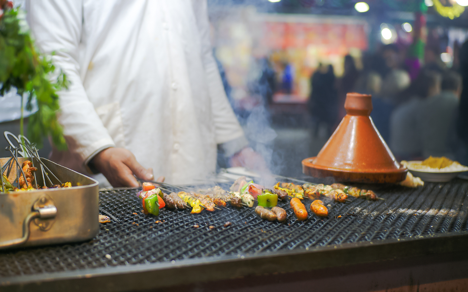Grilled skewers and tagine at Jema el Fna street food stall in Marrakesh.