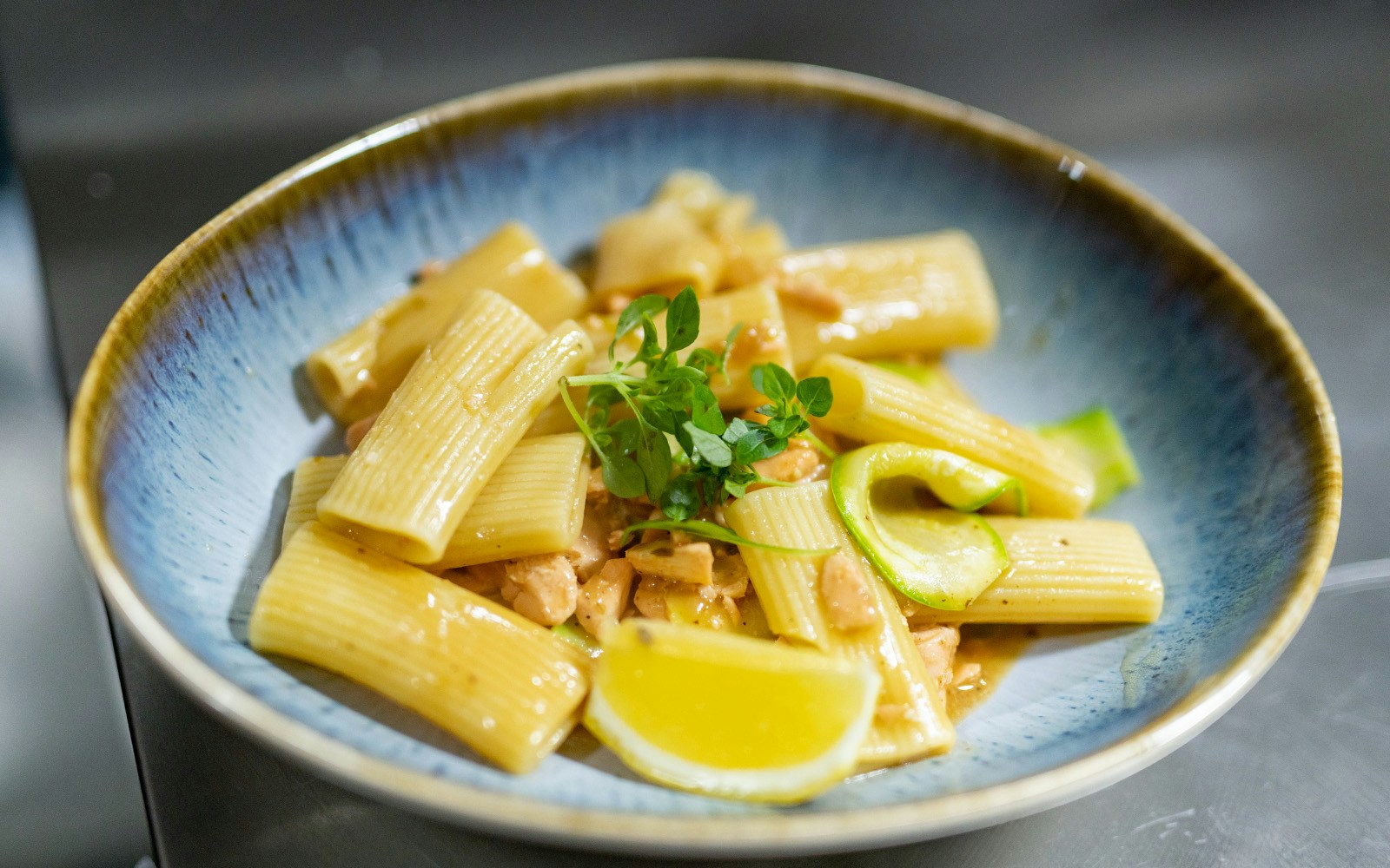 Fresh pasta dish on a brunch cruise boat with Paris skyline in the background.