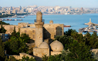 Palace of the Shirvanshahs with Baku cityscape and Caspian Sea in the background.