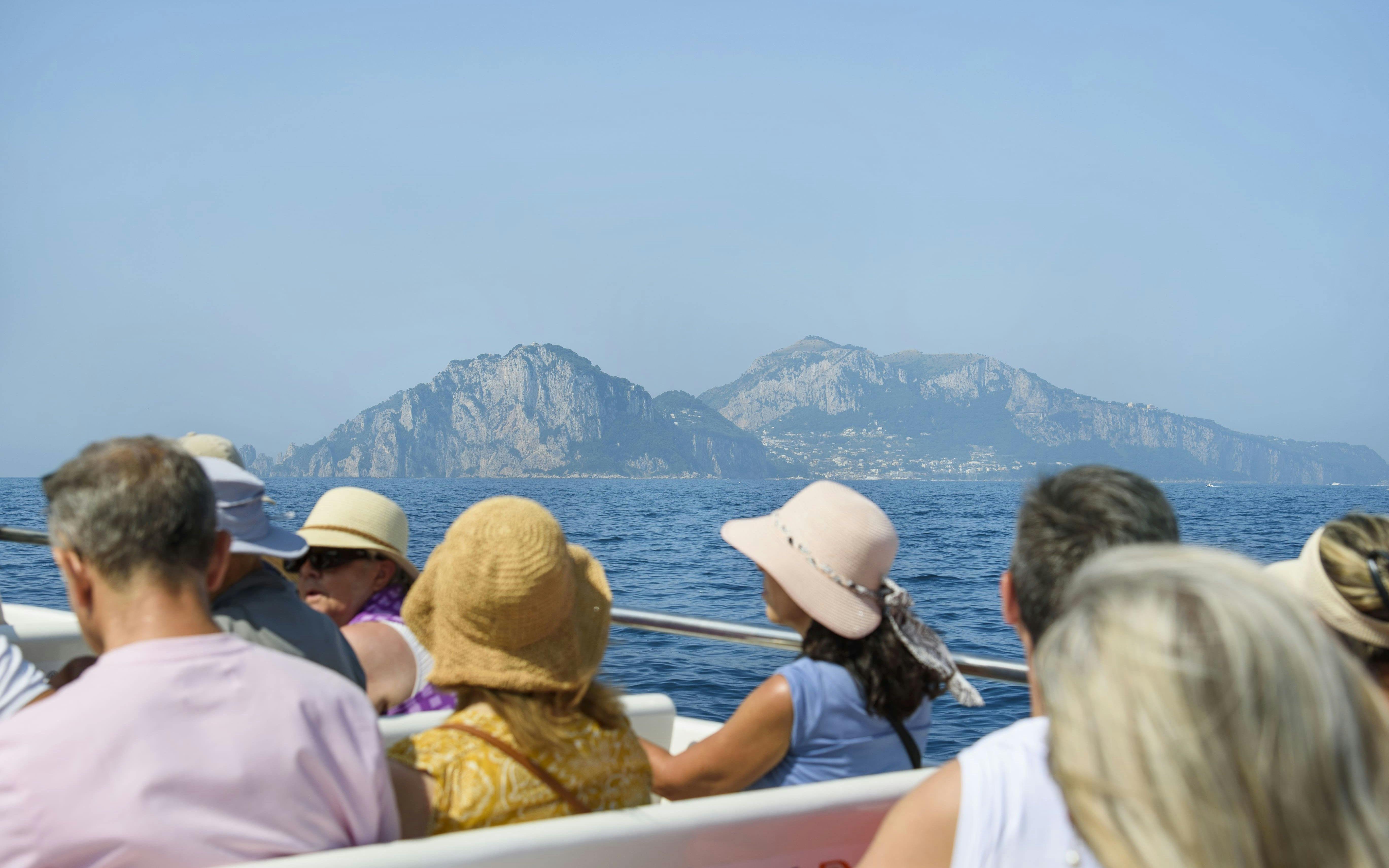 Tourists on a boat tour viewing the Amalfi Coast from Sorrento.