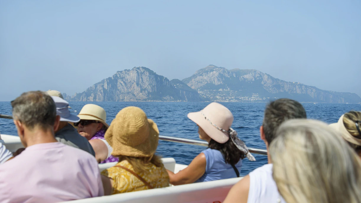 Tourists on a boat tour viewing the Amalfi Coast from Sorrento.