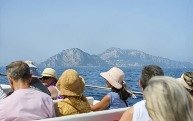 Tourists on a boat tour viewing the Amalfi Coast from Sorrento.