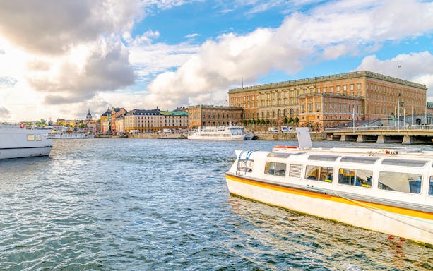 Strandvagskajen Promenade view with boats on Djurgrden City Canal Cruise.