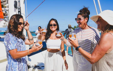 Group enjoying drinks on a Kaula Kai Sunset Sail in Oahu.
