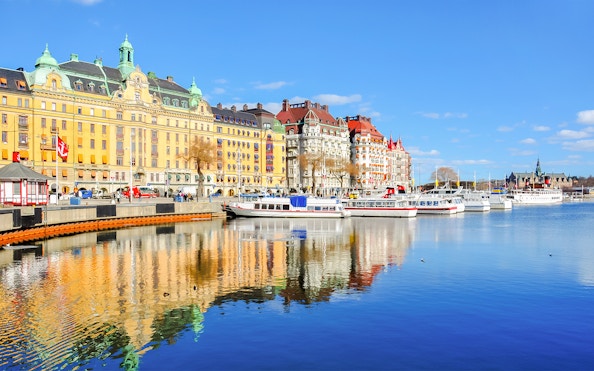 Canal cruise boats docked along Strandvagen embankment, Djurgrden City.