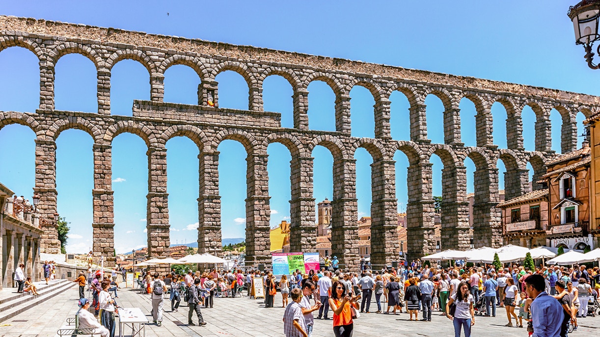Crowd gathered near the ancient Segovia aqueduct in Spain.