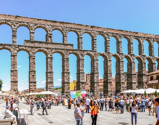 Crowd gathered near the ancient Segovia aqueduct in Spain.