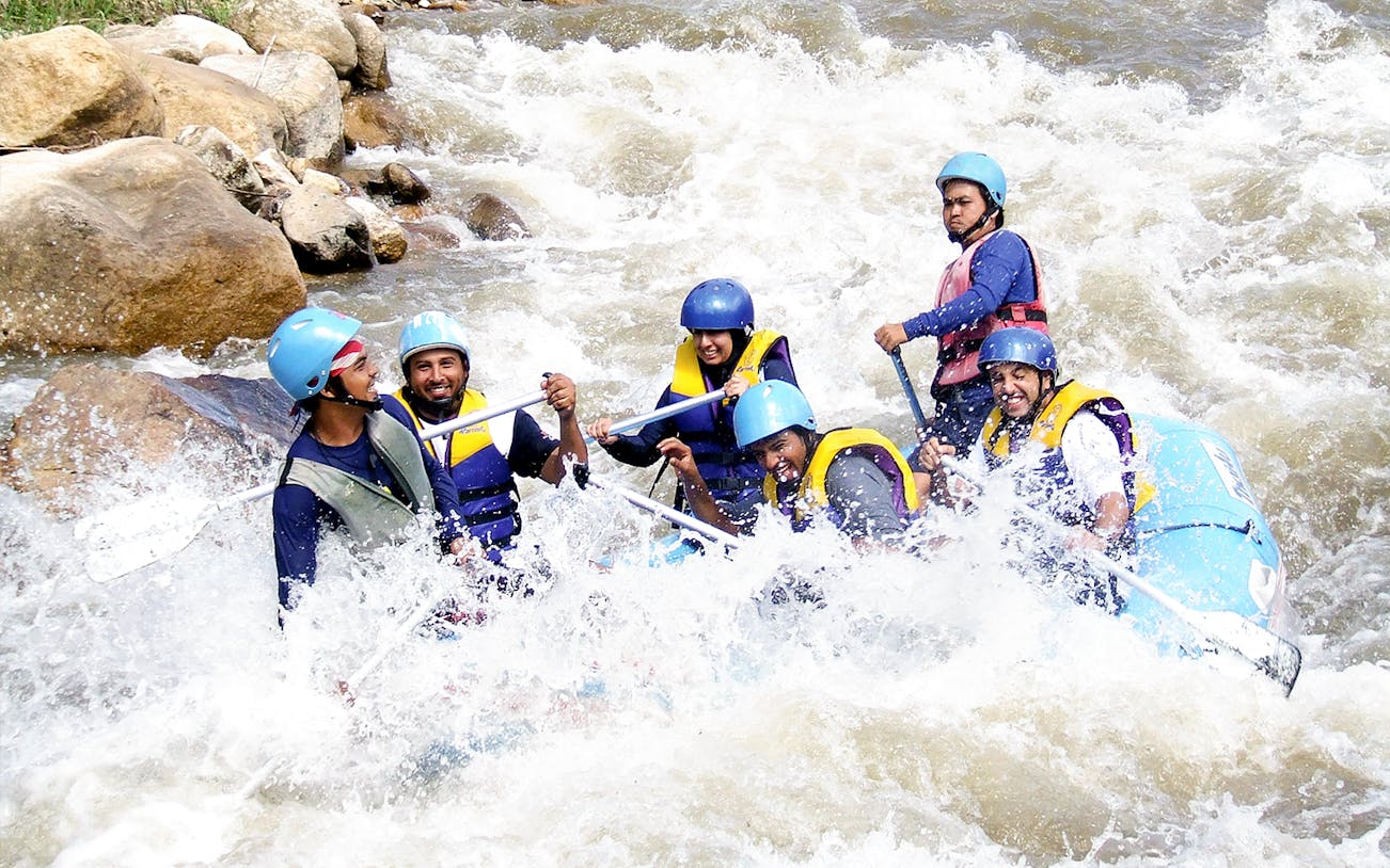 Tourists rafting through rapids in Phuket during a full day adventure.