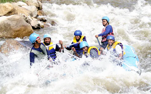 Tourists rafting through rapids in Phuket during a full day adventure.