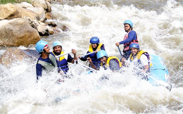 Tourists rafting through rapids in Phuket during a full day adventure.
