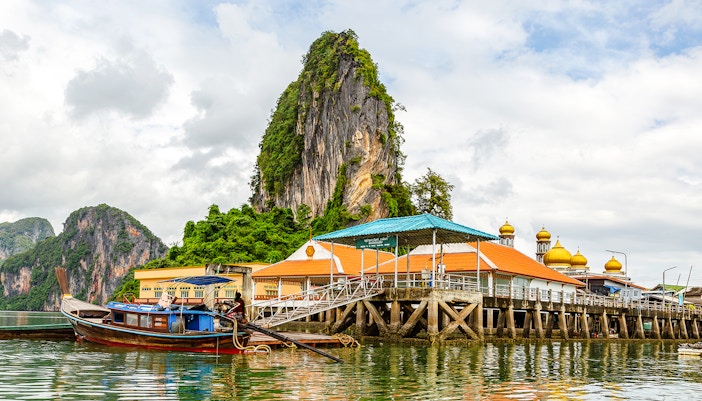 Koh Panyee floating village with limestone cliff and mosque, Thailand.