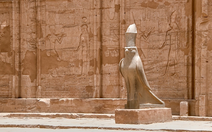 Stone statue of Horus at Edfu Temple entrance, Egypt.