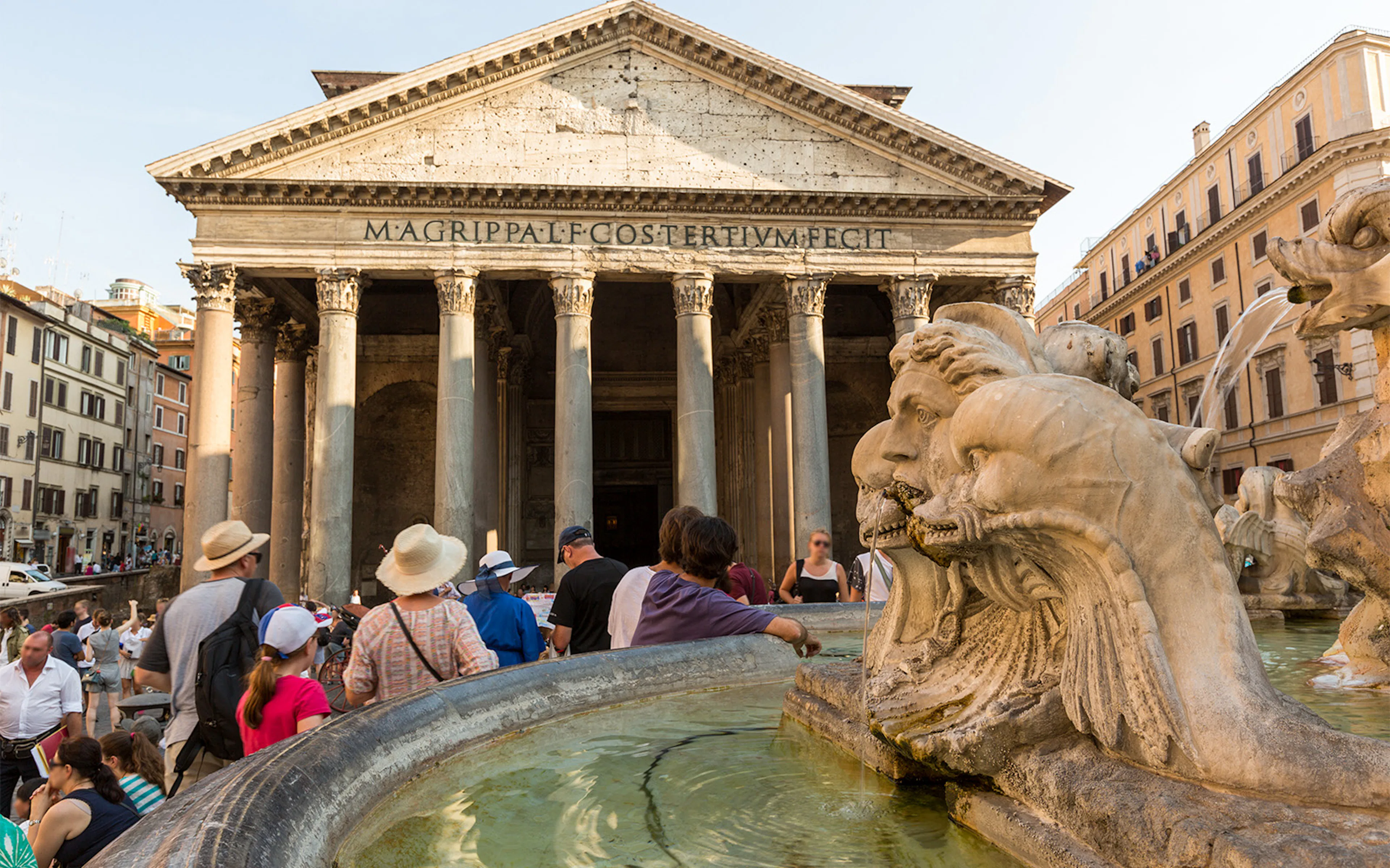Tourists gather near the fountain in front of the Roman Pantheon in Rome, Italy.