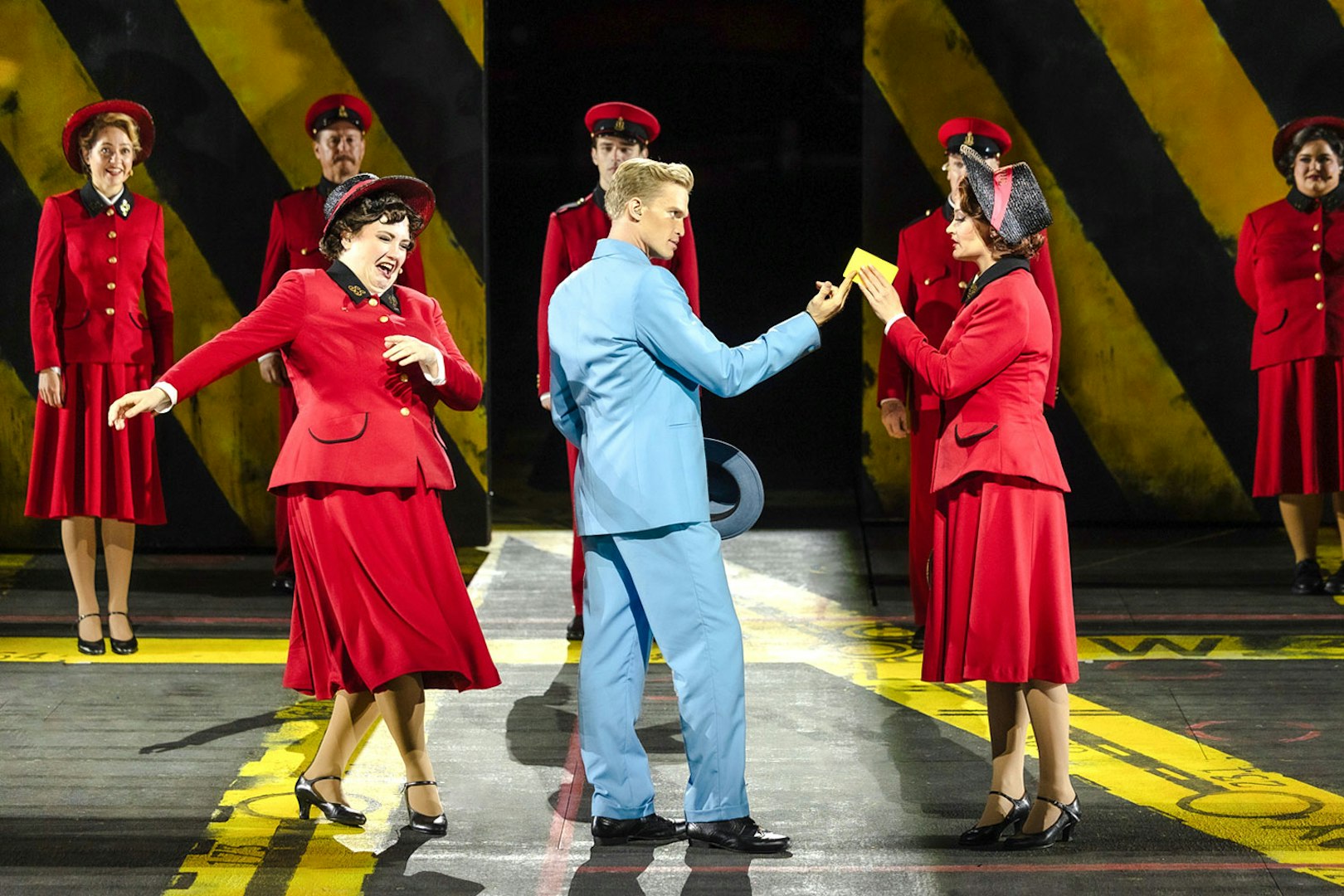 Performers in vibrant costumes during "Guys & Dolls" on Sydney Harbour stage.