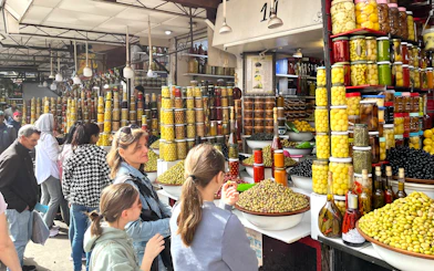 Market stall with jars of olives and preserved goods in Marrakech Medina.
