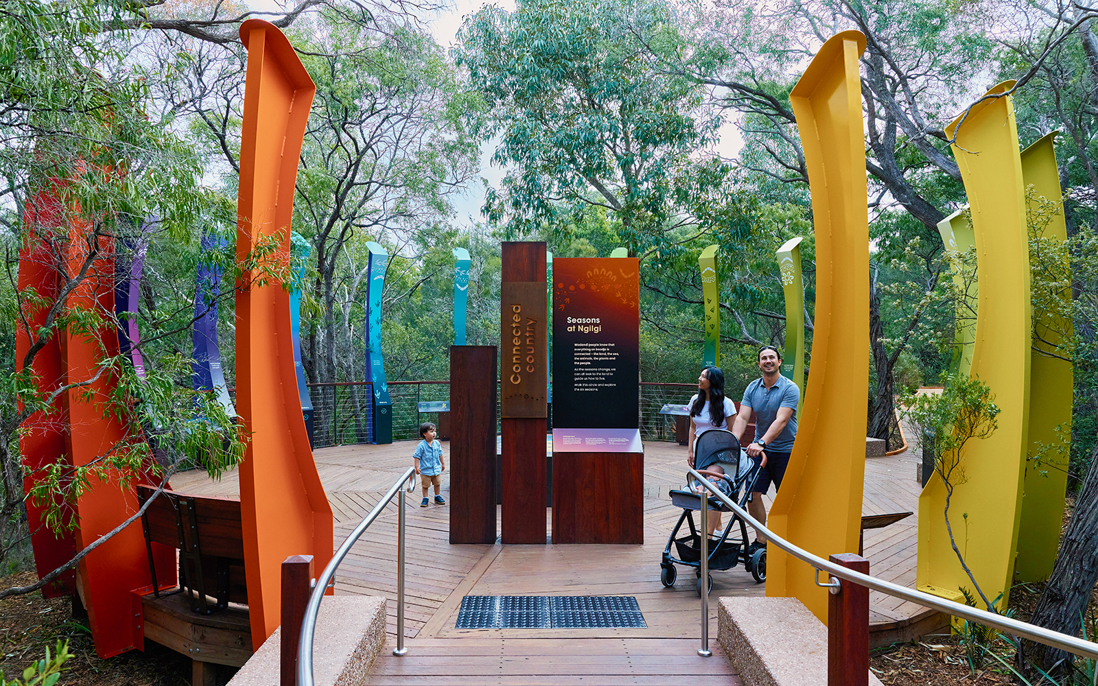 Ngilgi Cave entrance with colorful pillars and visitors exploring the Ancient Lands Experience.