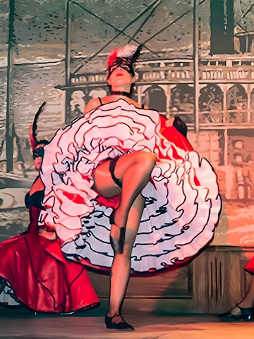 Performer in can-can dress dancing at Oasys Mini Hollywood, Spain.