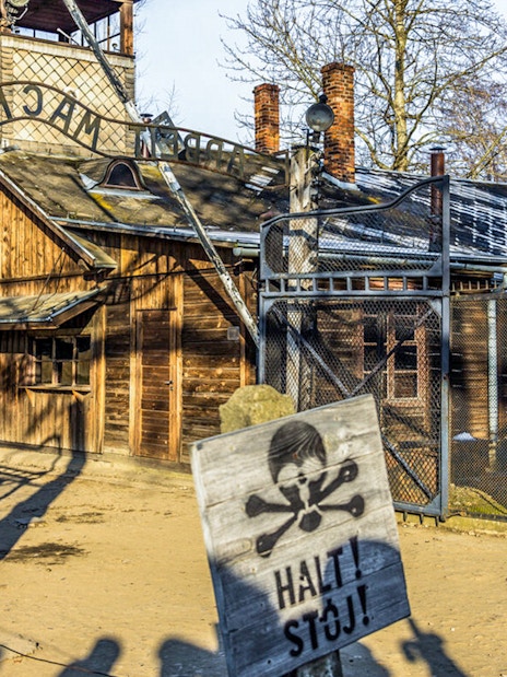 Auschwitz-Birkenau entrance gate with warning sign, part of guided tour from Krakow.