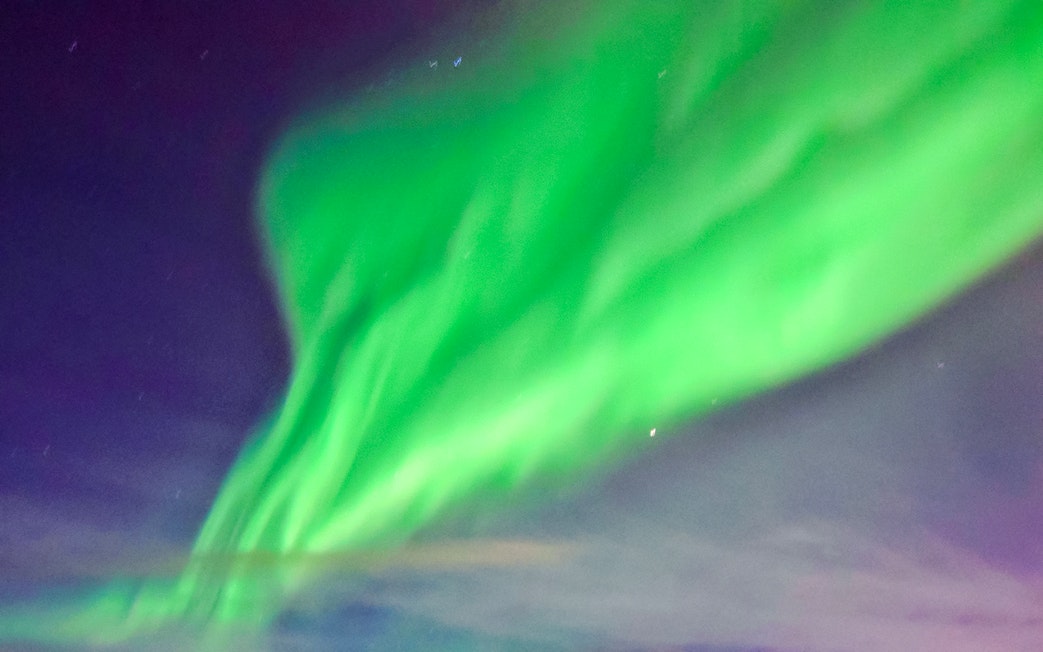 Northern lights display over a cruise ship in the Arctic.