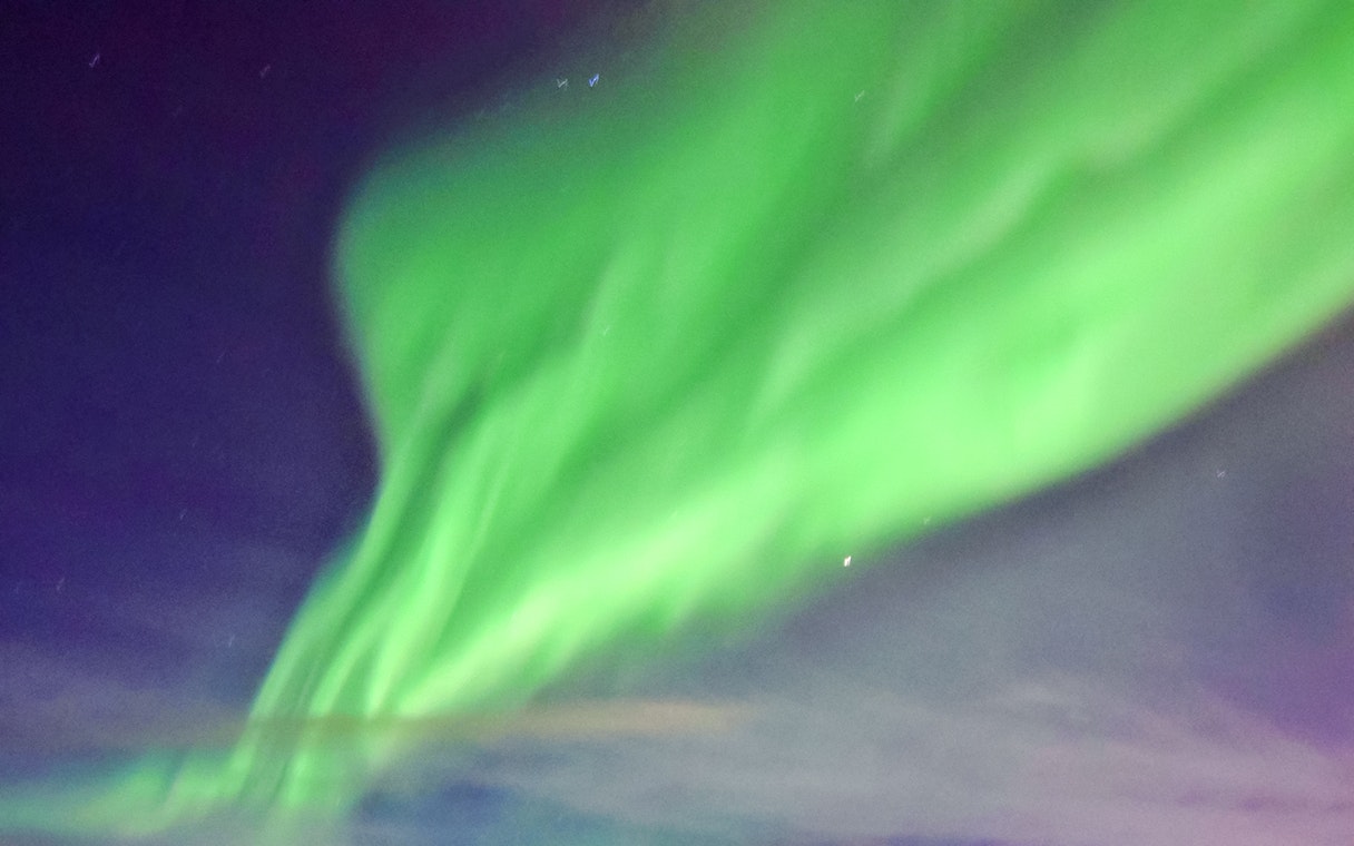 Northern lights display over a cruise ship in the Arctic.