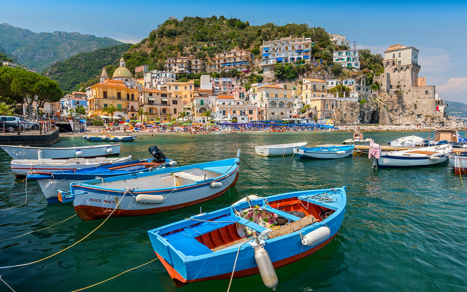 Naples Positano Amalfi coastline view from sea with colorful buildings and cliffs.