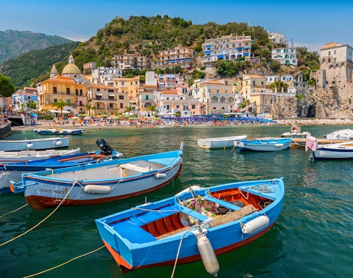 Naples Positano Amalfi coastline view from sea with colorful buildings and cliffs.
