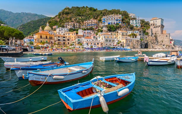 Boats in the harbor of a colorful coastal village on the Amalfi Coast, Italy.