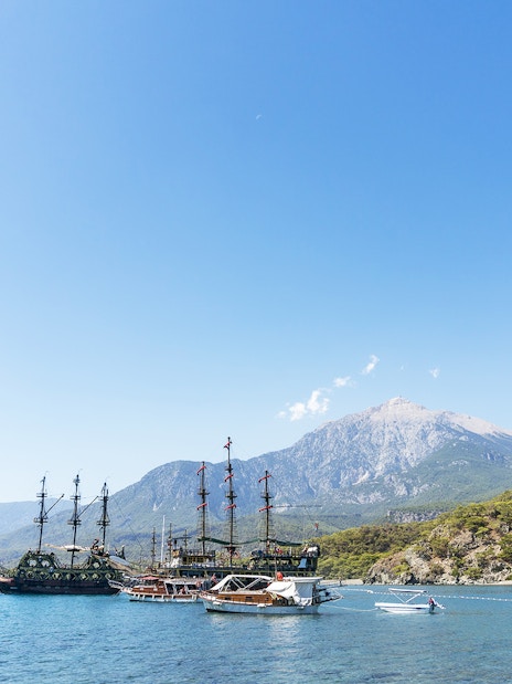 Boats anchored near Phaselis with mountains in the background, Antalya tour.
