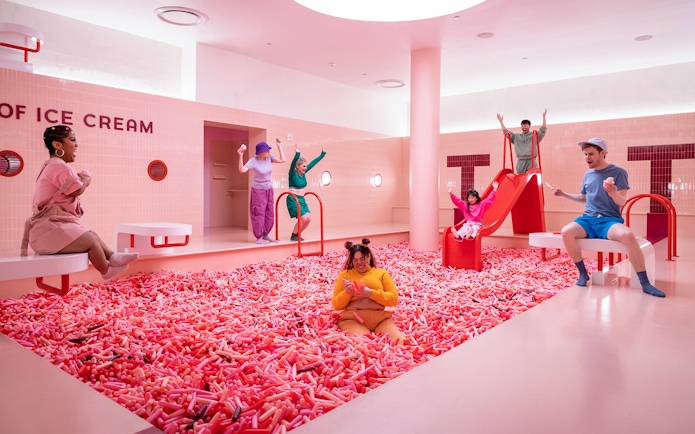 Visitors enjoying colorful exhibits at the Museum of Ice Cream in Singapore.