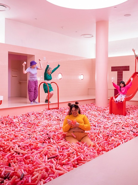 Visitors enjoying colorful exhibits at the Museum of Ice Cream in Singapore.