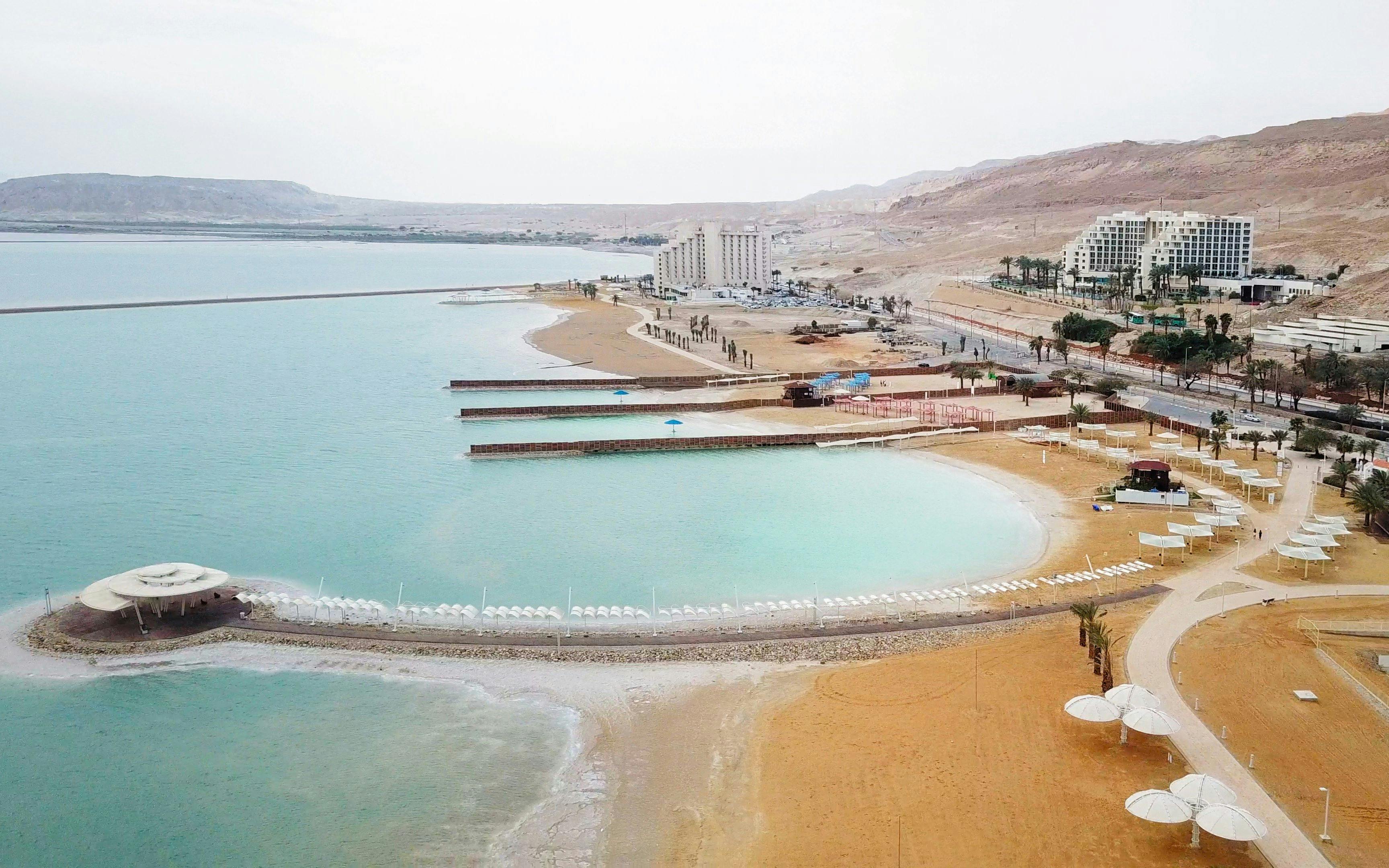 Aerial view of the Dead Sea coastline with hotels and beach umbrellas, Israel.
