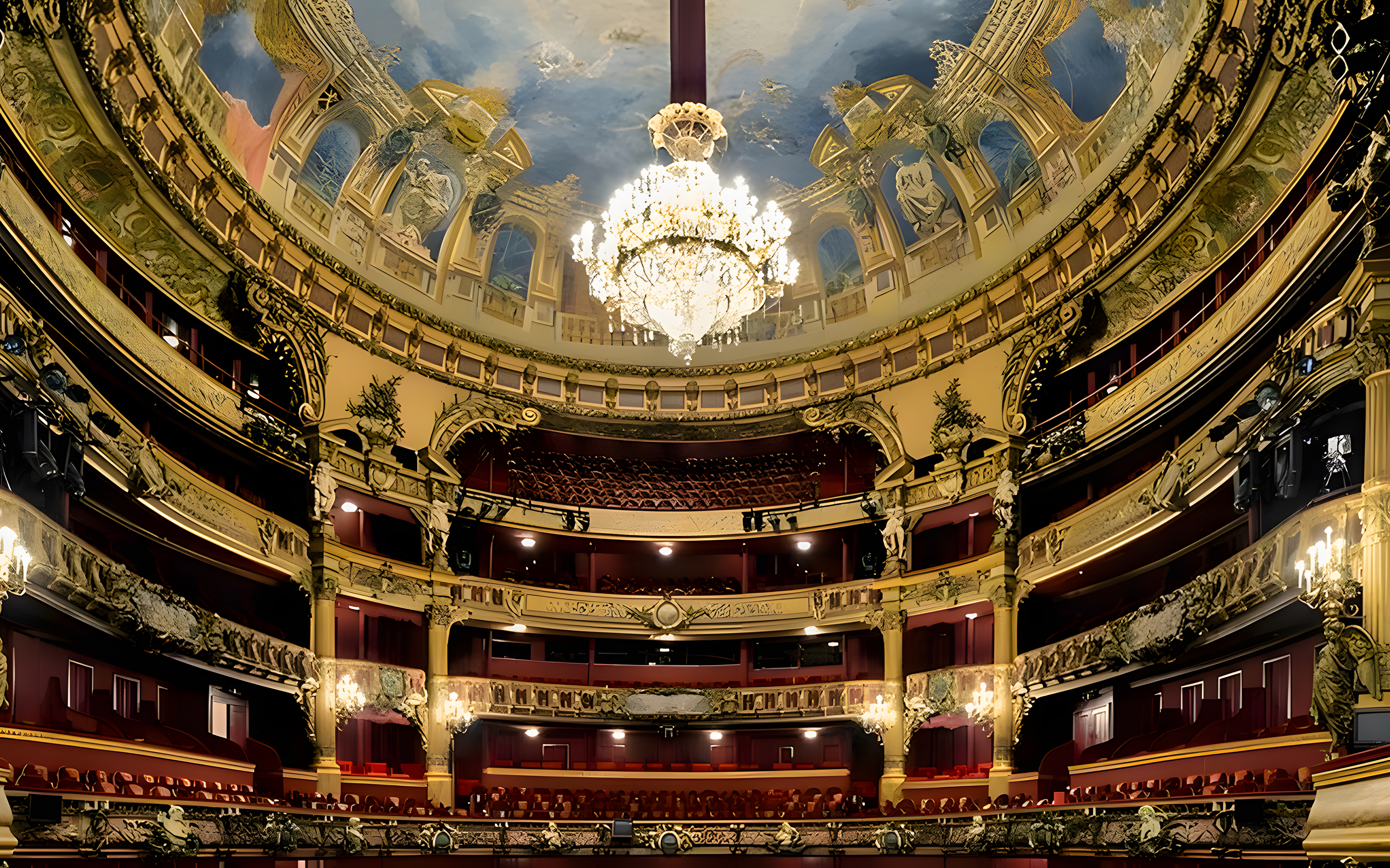 Teatro Colon interior with ornate balconies and grand chandelier.
