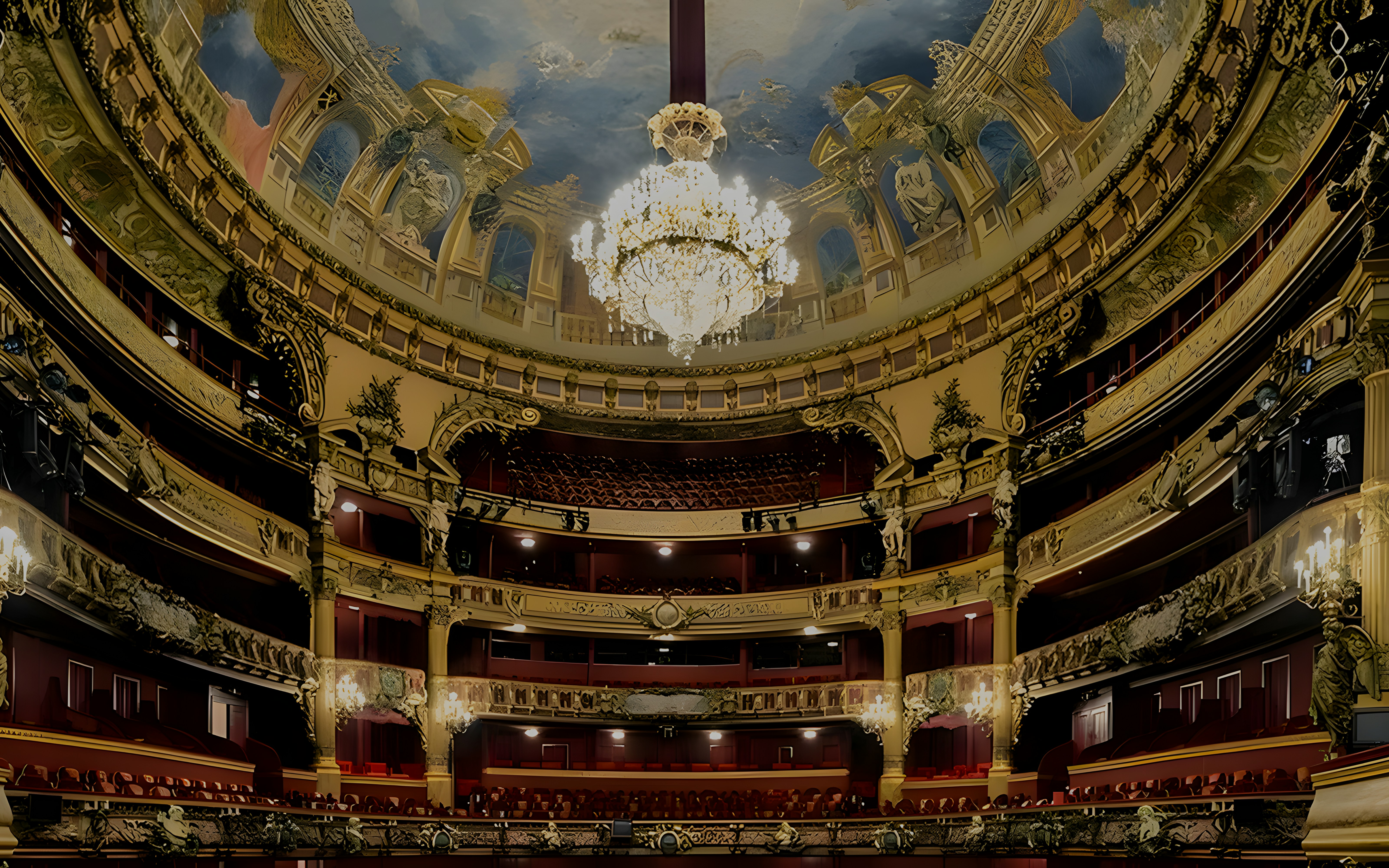 Teatro Colon interior with ornate balconies and grand chandelier.