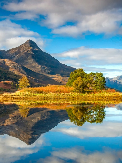 Scenic view of a mountain and lake reflection on the St Andrews & Fife tour from Edinburgh.
