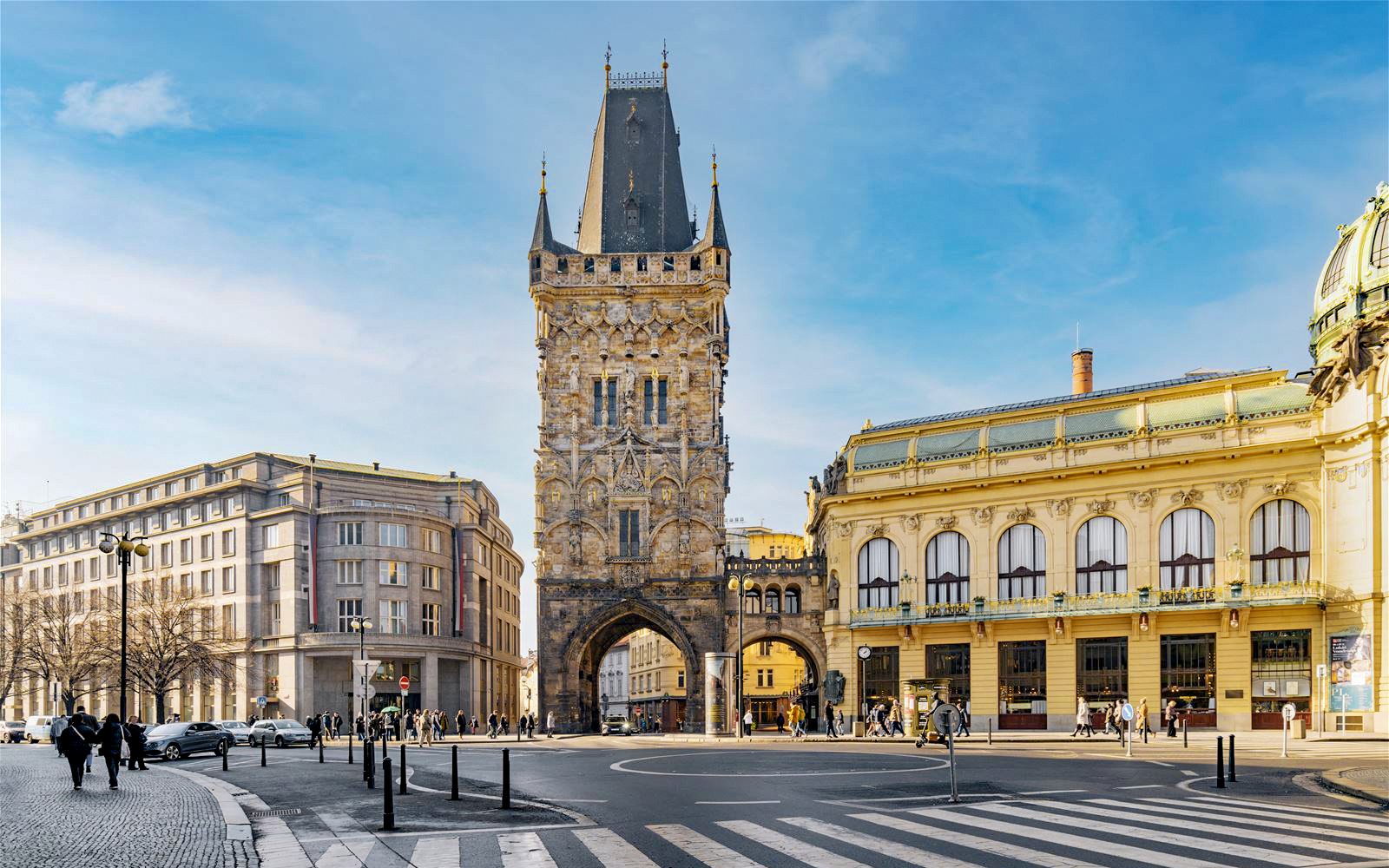 Powder Tower in Prague with surrounding historic buildings and street scene.