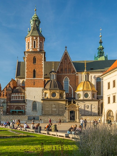 Wawel Cathedral exterior with tourists in Krakow, Poland.